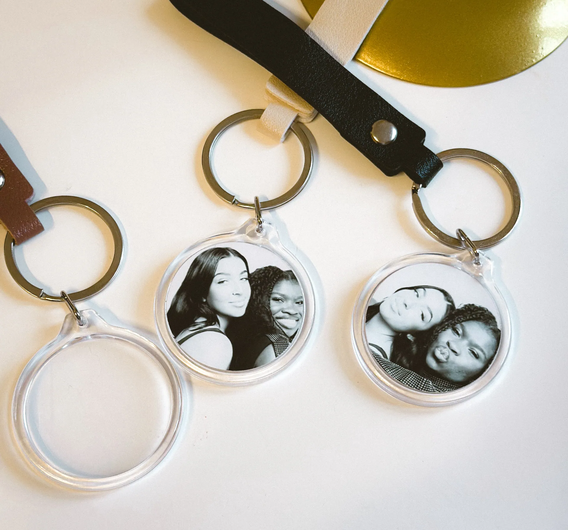 Finished round photo keychains with ribbon bands and photos inside