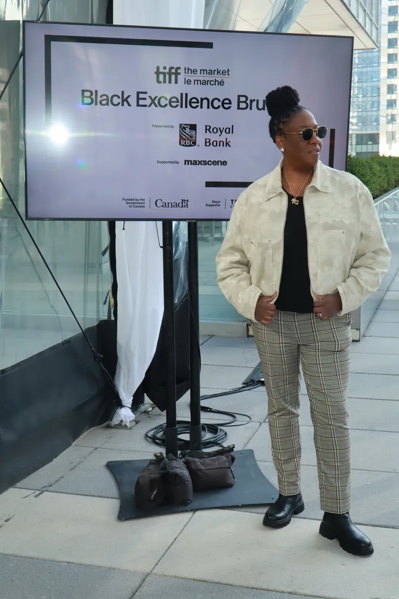 DJ JJ Rock standing beside Black Excellence Brunch signage during TIFF 2026