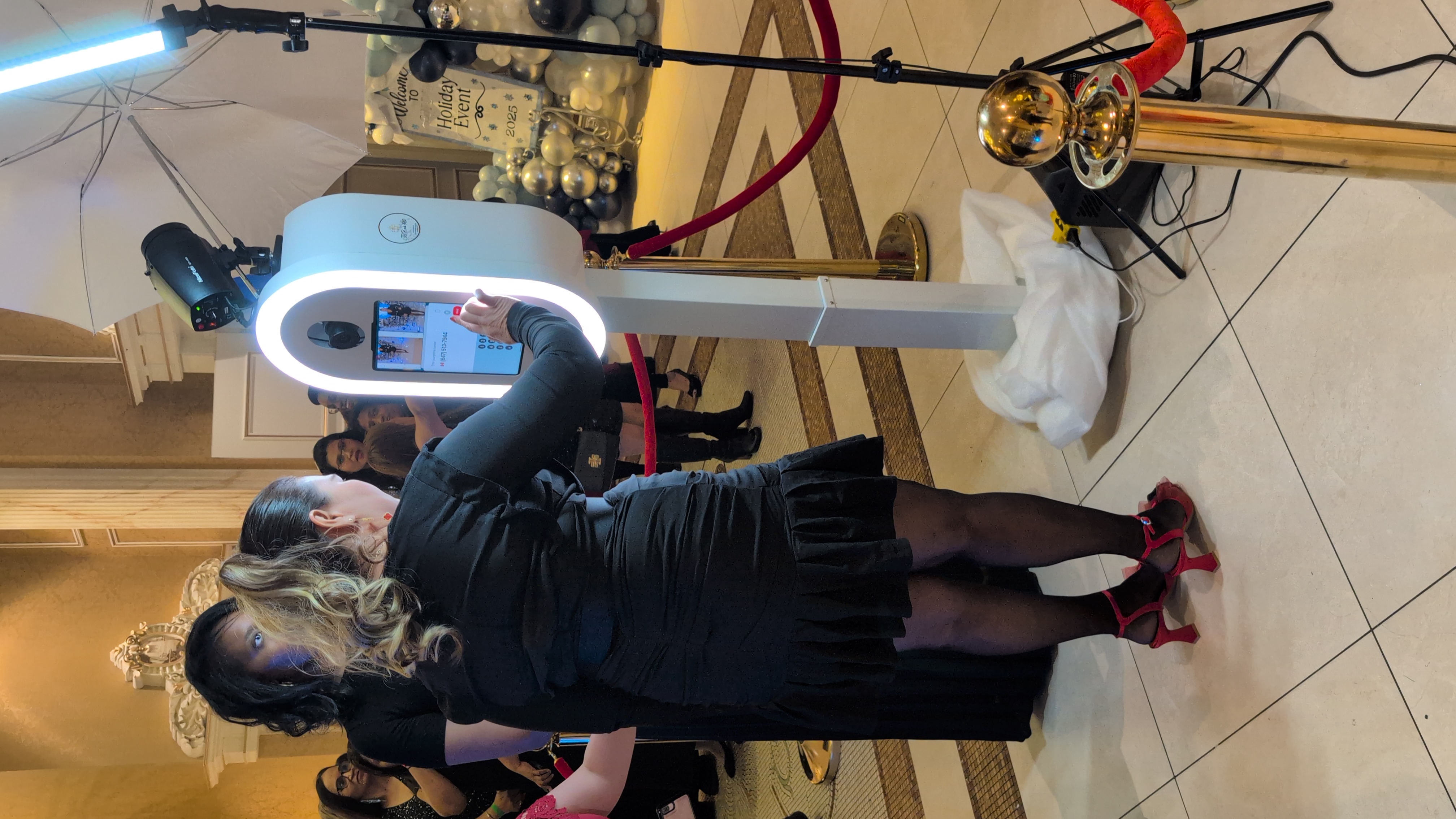 Holiday event guests using the white oval In Frame photo booth