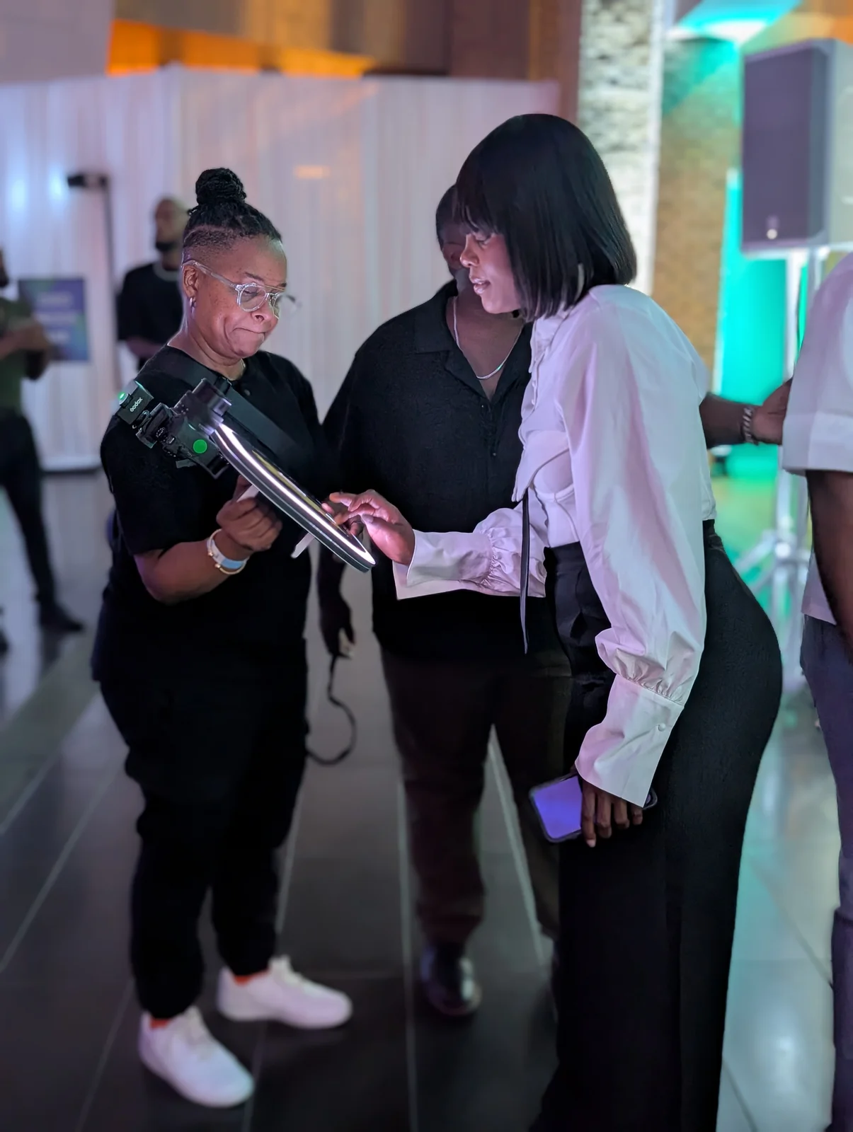 Jeannine helping guests use the handheld roaming photo booth