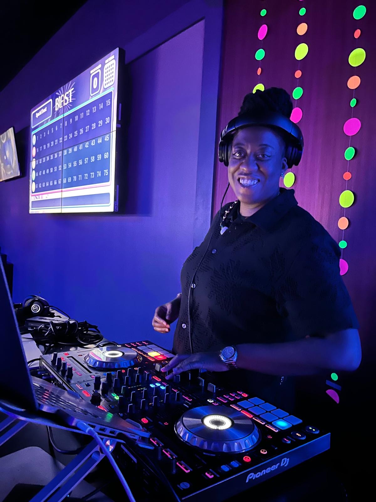JJ Rock at the DJ controller under the event's purple lighting