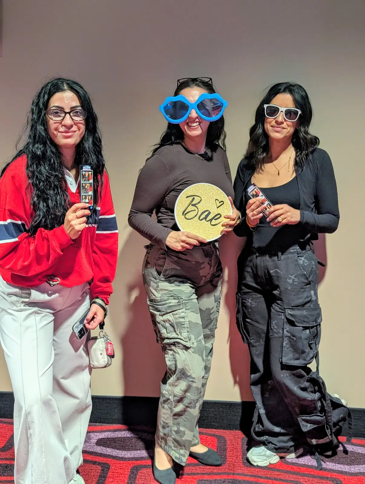 Three guests posing together at the corporate Glow Bingo photo booth