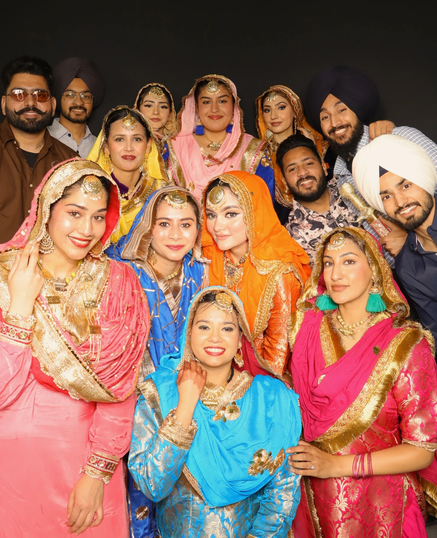 Guests posing together in colourful celebration outfits