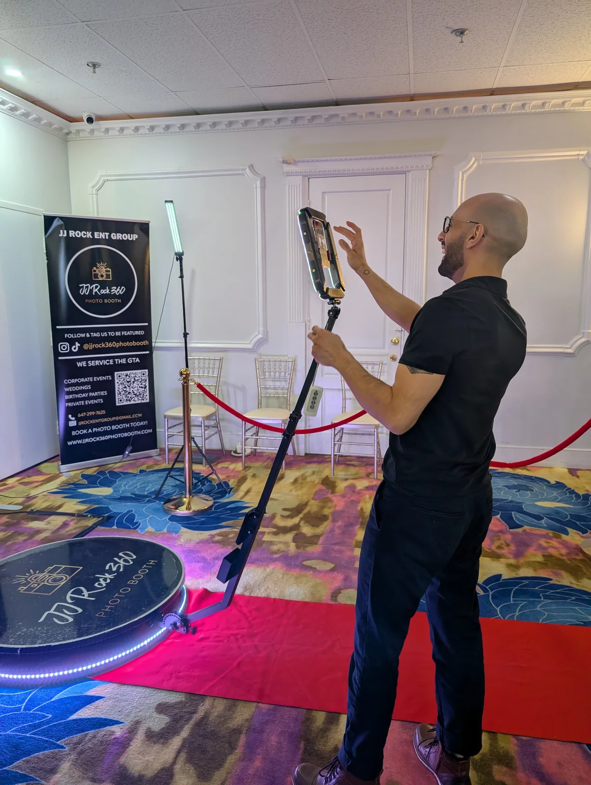Peter from the JJREG team operating the camera arm of a 360 video booth