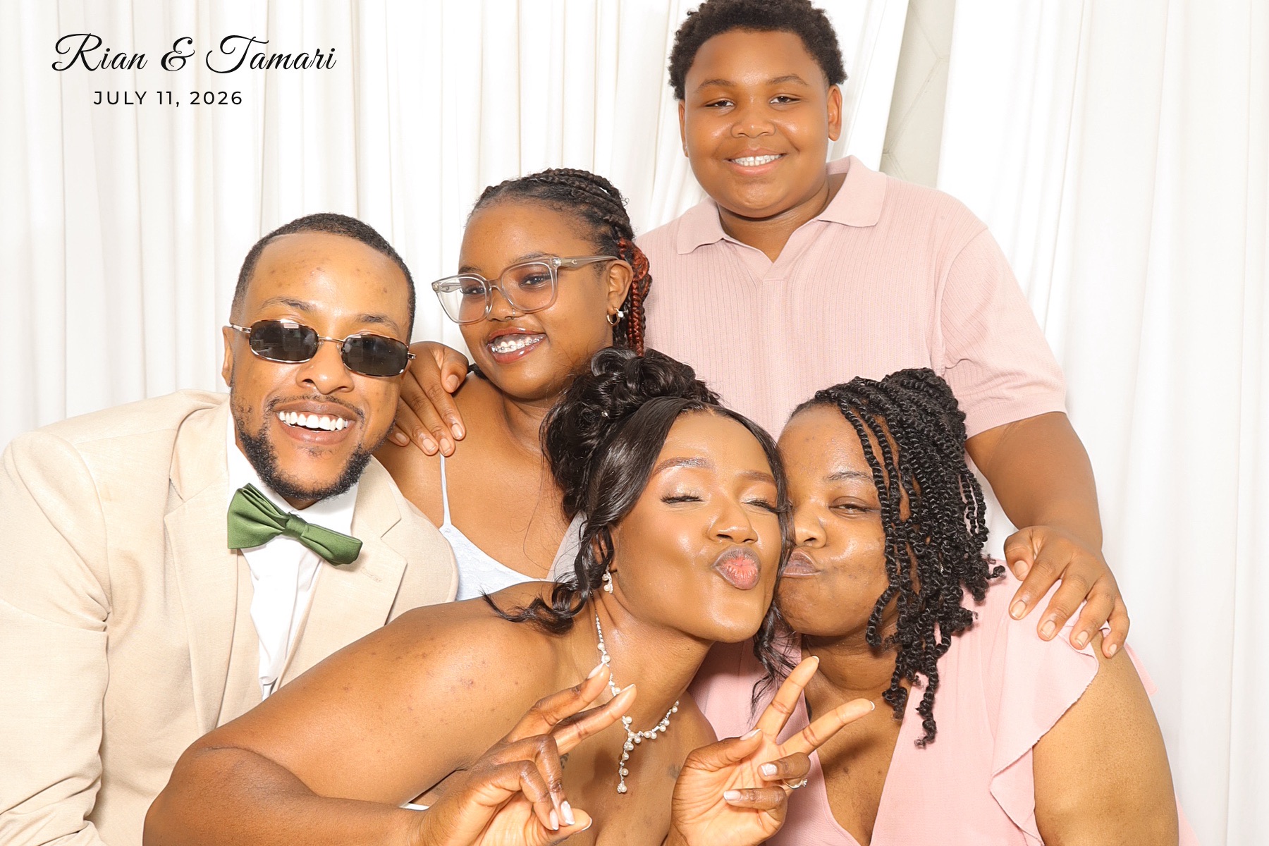 Bride and guests sharing a photo booth moment at Rian and Tamari’s wedding