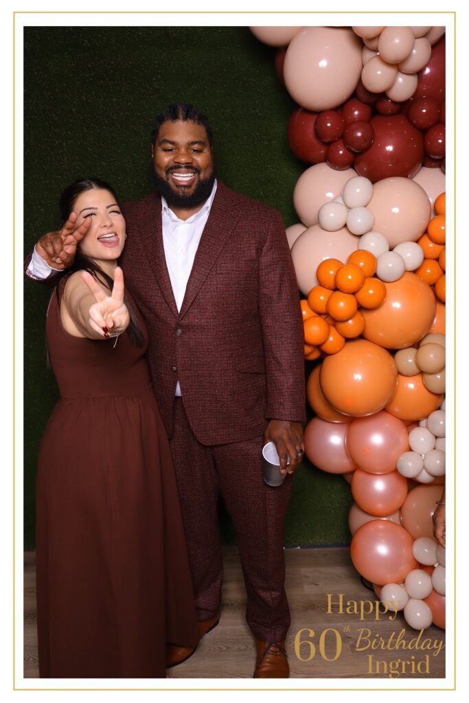 JJ Rock Entertainment Group – DJ and Photo Booth Services for a 60th birthday celebration in Toronto, featuring a bright autumn theme with balloon arch, green grass photo booth wall, and elegant portrait setup