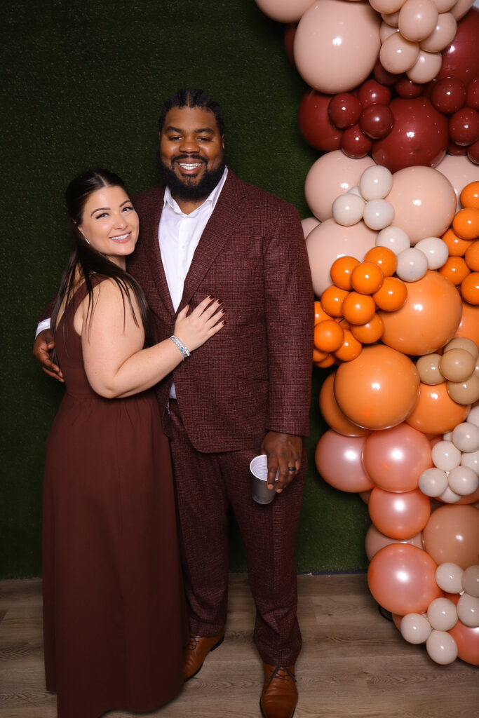 JJ Rock Entertainment Group – DJ and Photo Booth Services for a 60th birthday celebration in Toronto, featuring a bright autumn theme with balloon arch, green grass photo booth wall, and elegant portrait setup